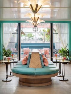 a living room filled with furniture and windows