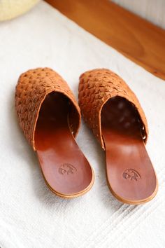 Our classic mule–elevated design, slipper feel. Featuring a butter-soft handwoven weave and our classic molded leather sole. 100% vegetable-tanned leather arch support ¼” heel height Materials: The upper is handwoven with the highest quality vegetable-tanned leather. Soles are 100% leather with a non-slip heel. Sizing: The Nudo Mixteco weave will easily shape to your foot within a few wears. If you are between sizes and have a narrow foot, size down. If you have a wider foot, size up. Note: Vege Pottery Coasters, Pottery Candle, Basket Tote, Shoe Inspo, Water Droplets, Leather Slides, Linen Clothes, Vegetable Tanned Leather, Arch Support