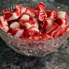 a glass bowl filled with sliced up strawberries