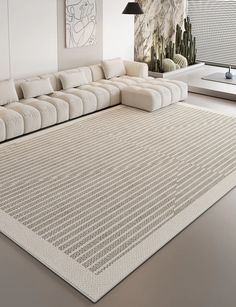 a large white couch sitting on top of a living room floor