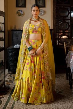 Lime yellow lehenga with multi colored floral print and hand embroidered highlights. Comes with matching silk based padded blouse and tissue based dupatta, heavily embellished with hand embroidery and detailing full of beads and sequins.
Components: 3
Pattern: Printed, Hand Embroidered
Type Of Work: Floral Patterns
Neckline: Plunged V-Neck
Sleeve Type: Sleeveless
Fabric: Lehenga and blouse : Chiniya silk, Dupatta : Tissue
Color: Yellow
Other Details: 
Lehenga:
Attached lining
Embroidered highlig Paulmi And Harsh, Lehenga And Blouse, Printed Lehenga, Floral Lehenga, 1950’s Fashion, Organza Lehenga, Yellow Lehenga, Embroidery Beads, Lime Yellow