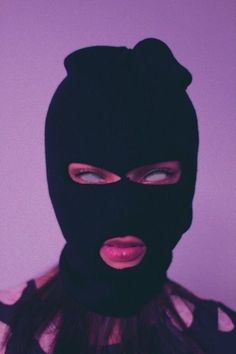 a woman wearing a black mask with pink lips