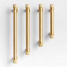 three brass colored handles are shown against a white background and the top one is empty