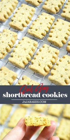 a hand holding up a shortbread cookie in front of a rack with cookies on it