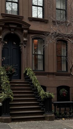 an old building with stairs leading up to the front door