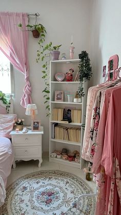 a bedroom with a rug, bed and shelves filled with clothes on it's sides