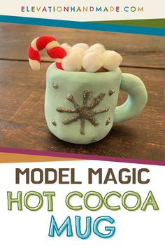 a mug with marshmallows and candy cane in it is featured for the model magic hot cocoa mug