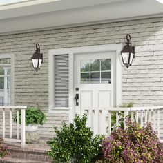 a white front door with two lights on each side and flowers in the foreground