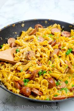 a skillet filled with pasta and sausage