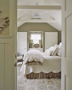 an open door leading to a bedroom with white walls