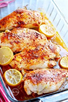 chicken with lemons and sauce in a glass dish