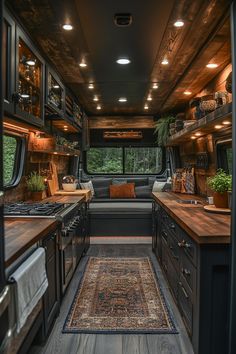 the interior of a camper with wood flooring and cabinets, including an area rug