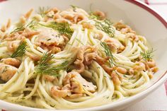 a white bowl filled with pasta and meat