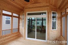 the inside of a house with wood paneling and sliding glass doors