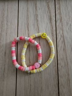 Smiley Bracelets can be customized for children and adults Affordable Trendy Stretch Bracelet With Smiley Face, Adjustable Yellow Playful Bracelets, Playful Adjustable Yellow Bracelets, Yellow Adjustable Playful Bracelets, Handmade Adjustable Plastic Friendship Bracelets, Handmade Adjustable Bracelets For Party Favors, Adjustable White Letter Beads Craft Supplies, Handmade Plastic Bracelets For Birthday, Adjustable Personalized Plastic Bracelets