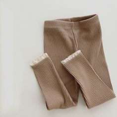 These stylish unisex leggings are made of soft cotton and have long ribbed cuffs for a chic and trendy appearance. The neutral colors make them versatile and easy to pair with any top. With full length coverage, reinforced seams, and an elastic waist, these leggings offer both style and comfort. Toddler Bottoms, Ruffle Leggings, Lace Leggings, Lace Cuffs, Ribbed Leggings, Baby Leggings, Knit Leggings