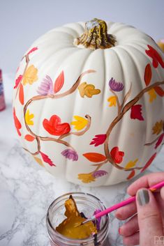 someone is painting a pumpkin with acrylic paint