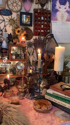 a table topped with lots of books and candles