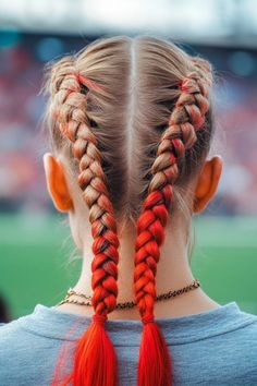 Woman with two French braids dyed red at the ends, viewed from behind. Braids Curls