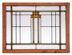 an old stained glass window with wooden frame and gold trimmings on the sides