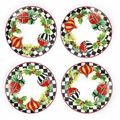 four plates decorated with christmas ornaments and holly on checkerboard pattern, each plate has an ornament in the center