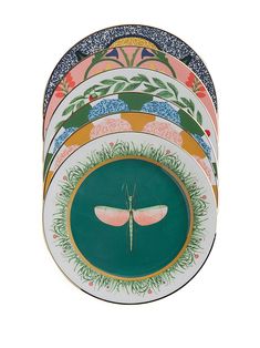 a stack of colorful plates with designs on each plate and an insect painted on the side