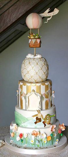 a three tiered cake with an air balloon on top