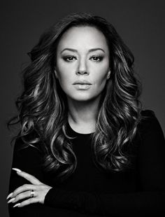 a black and white photo of a woman with her arms crossed