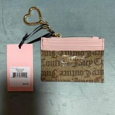 This Is A Brand New With Tags, Completely Packaged, Juicy Couture, Los Angeles, California Card Holder, Change Purse, Id Tag Holder, Bag Charm. The Front Has A Brown, Juicy Couture , Pattern Canvas With Pink Layers Behind Them. The Inside Lining Is Beige Fabric With Black, Juicy Couture Writing On It. Room To Hold Two Cards. There Is The Word Juicy In A Gold Emblem. The Top Has A Golden Zipper. Attached To The Zipper Is A Gold Chain With A Gold Heart That Clasps Open To Attach To Your Bag Or Bac Trendy Pink Wallet With Zipper Pouch, Trendy Pink Wallet, Trendy Pink Wallet For Personal Use, Trendy Pink Wallets For Personal Use, Trendy Pink Coin Purse With Zipper, Pink Card Holder With Zipper Closure As Gift, Juicy Wallet, Pink Card Holder With Zipper Closure For Daily Use, Brown Juicy Couture