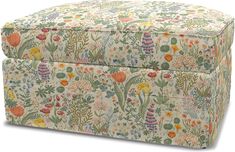 an upholstered ottoman with colorful flowers and plants on the top, sitting in front of a white background