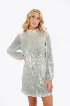 KIELLE SILVER MOCK NECK SEQUIN MINI DRESS Fitted Sequin Mini Dress, Glamorous Sequin Dress For Holiday Party Season, Long Sleeve Dressy Sequin Dress For Holiday Party, Dressy Long Sleeve Sequin Dress For Holiday Party, Glamorous Sequined Mini Dress For Holidays, Holiday Chic Sequin Dress With Contrast Sequin, Chic Holiday Sequin Dress With Contrast Sequin, Sparkling Mini Dress For Formal Parties, Glamorous Sparkling Sequin Dress For Spring