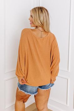 Keep your weekend style simple with this casual plus size pumpkin colored shift top featuring lightweight material with subtle horizontal accent stripes, a rounded neckline, long batwing sleeves, and a slouched silhouette that falls into a straight hemline! Measurements 1XL : Bust 40", Hip 40", Length 27", Sleeve Length 24", Waist 40". 2XL : Bust 42", Hip 42", Length 27", Sleeve Length 25", Waist 42". 3XL : Bust 44", Hip 44", Length 27", Sleeve Length 25", Waist 44". Fall Orange Top For Everyday, Orange Top For Everyday Fall Wear, Orange Everyday Top For Fall, Oversized Ribbed Brown Top, Fall Ribbed Neckline Batwing Sleeve Tops, Oversized Ribbed Top With Batwing Sleeves, Oversized Ribbed Batwing Sleeve Top, Pumpkin Colors, Weekend Style