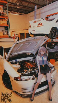 a woman sitting on the hood of a car in a garage with other cars behind her