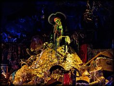 a display in a store filled with lots of gold coins and skeleton figurines