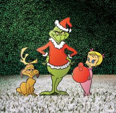 the grinch family standing in front of a hedge