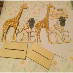 two giraffes are standing next to each other on a sheet of paper