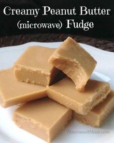 four pieces of creamy peanut butter microwave fudge on a white plate