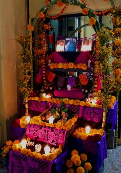 the altar is decorated with flowers, candles and decorations for day of the dead celebrations