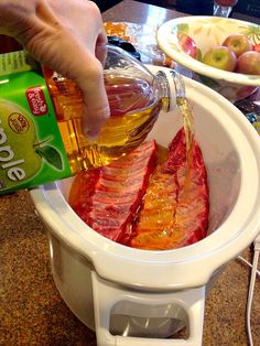 someone is pouring oil into a slow cooker