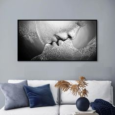 a black and white painting on the wall above a couch