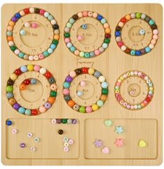 a wooden board with beads and magnets on it