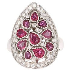 This ring has multiple Pear Cut Natural Red Rubies weighing 1.83 Carats and 41 Round Cut Diamonds weighing 0.51 Carats. The clarity and color of the diamonds are VS-H. The total carat weight of the ring is 2.34 Carats. The ring is beautifully casted in 14K White Gold and weighs approximately 8.5 grams. The design of this ring has a subtle antique inspired finish. It is a size 7 and can be re-sized at no additional cost.