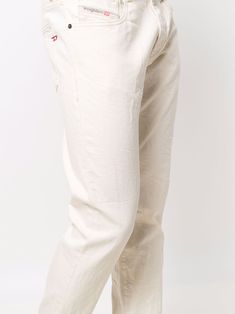 Off-white cotton-blend 2019 slim-cut jeans from DIESEL featuring front button fastening, two diagonal pockets to the sides, two rear patch pockets and slim cut. Conscious: This item is made from at least 50% organic materials. | Diesel 2019 Slim-Cut Jeans Diesel Clothing, Organic Materials, Cut Jeans, Slim Fit Jeans, Khaki Pants, Sweatpants, Cotton Blend, Slim Fit, Off White