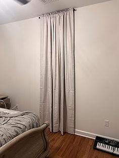 a bedroom with white walls and wood floors