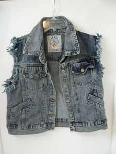 This vest is in good pre-owned condition that shows no stains and rips.  Vest has fringe arms.  Measures from armpit to armpit it is 20".   JE-2 Punk Denim Vest, Fitted Denim Vest Grunge Style, Fitted Grunge Denim Vest, Distressed Cotton Denim Vest In Washed Blue, Distressed Washed Blue Cotton Denim Vest, Trendy Distressed Blue Denim Vest, Trendy Blue Distressed Denim Vest, Grunge Denim Vest With Pockets, Distressed Denim Blue Cotton Vest