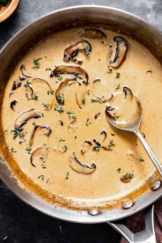 a skillet filled with mushroom soup and garnished with parsley on the side