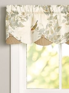 a window with a bird on the valance and two windowsills in front of it