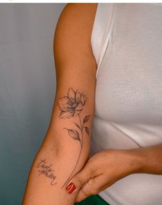 a woman with a flower tattoo on her arm