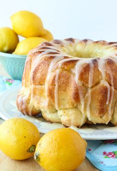 a bundt cake sitting on top of a table next to lemons