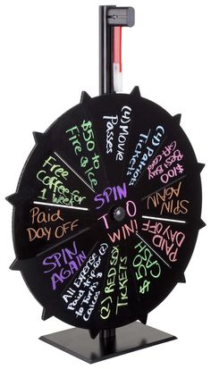 a spinning wheel with words written on the front and sides, all in different colors